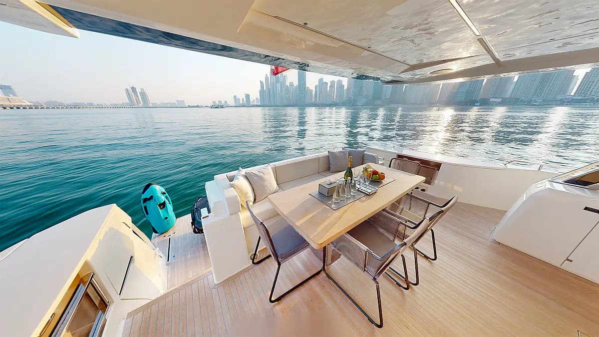 Ferretti 780 Solace — aft deck with seating and the Dubai coastline