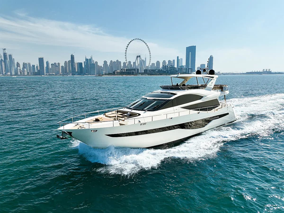 Galeon 780 Bella, a private charter yacht rather than a dhow, underway off Dubai with Ain Dubai behind